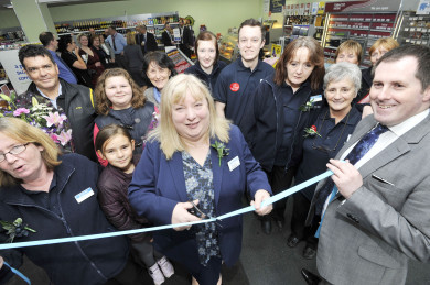 Store Manager Rose Spence cuts the ribbon to open the store.